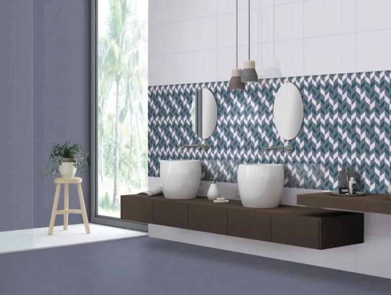 Blue bathroom featuring a double sink with mirror, large window, and trendy fabric textures